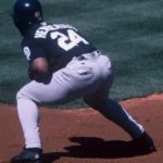 Rickey Henderson crouching at first for the San Diego Padres