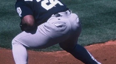 Rickey Henderson crouching at first for the San Diego Padres