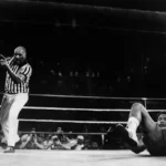 Muhammad Ali watching George Foreman on the canvas.