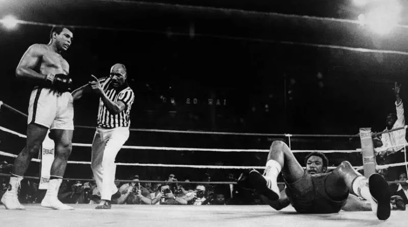 Muhammad Ali watching George Foreman on the canvas.