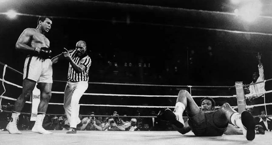 Muhammad Ali watching George Foreman on the canvas.